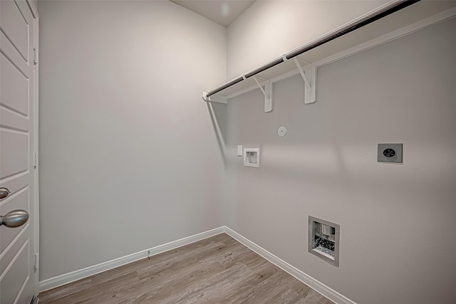 laundry area with laundry area, baseboards, hookup for a gas dryer, hookup for a washing machine, and hookup for an electric dryer