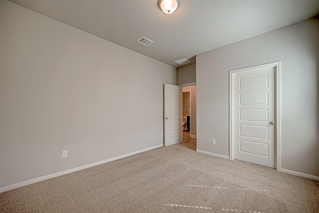 unfurnished bedroom with light colored carpet, visible vents, and baseboards