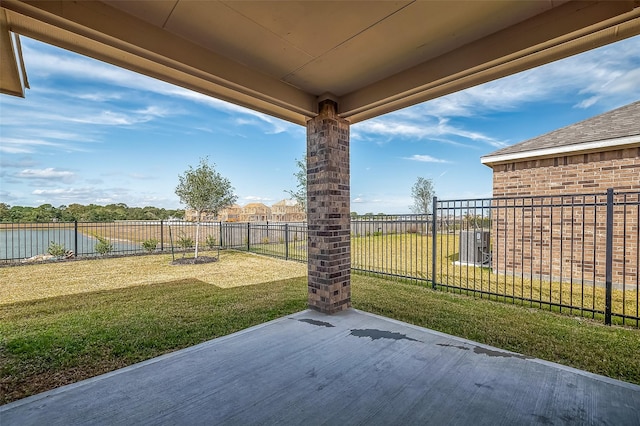 view of patio with a water view and a fenced backyard