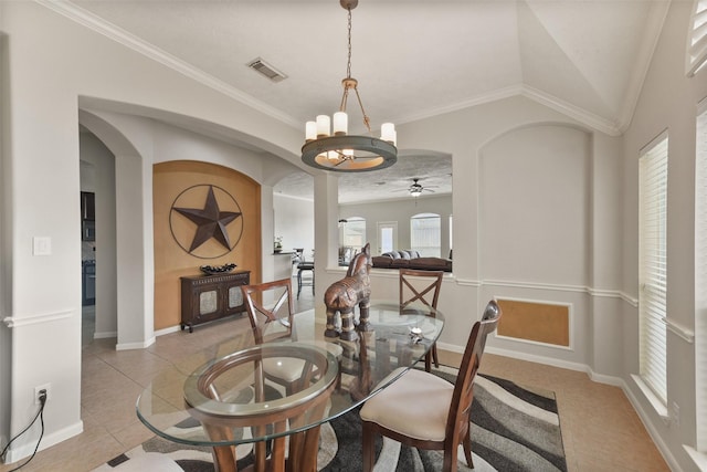 dining area featuring lofted ceiling, visible vents, arched walkways, and ornamental molding