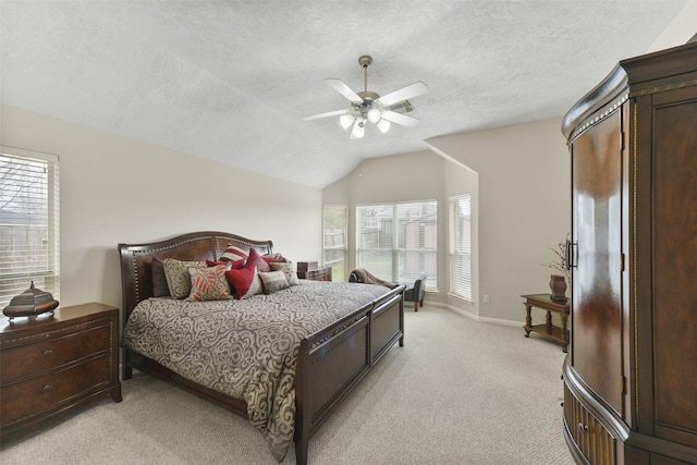 bedroom with a textured ceiling, lofted ceiling, light carpet, a ceiling fan, and baseboards