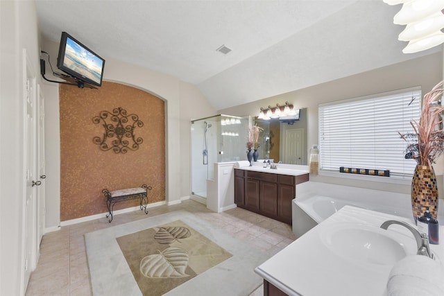 full bathroom featuring a stall shower, visible vents, two vanities, a sink, and a bath