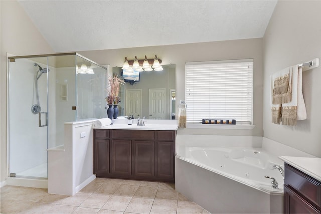 bathroom featuring a stall shower, vanity, a tub with jets, and a textured ceiling