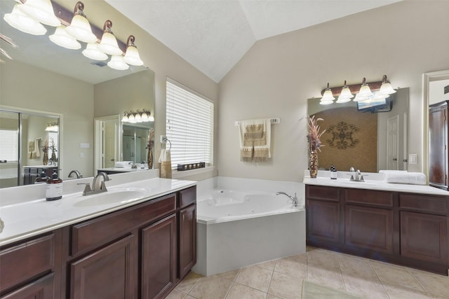 full bathroom featuring lofted ceiling, two vanities, a sink, and a tub with jets