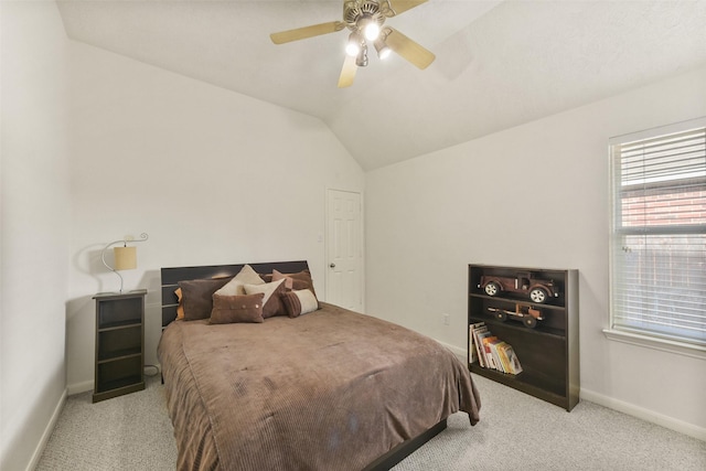 bedroom with vaulted ceiling, ceiling fan, baseboards, and light colored carpet