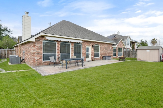 rear view of property with an outbuilding, a patio area, brick siding, and a storage unit