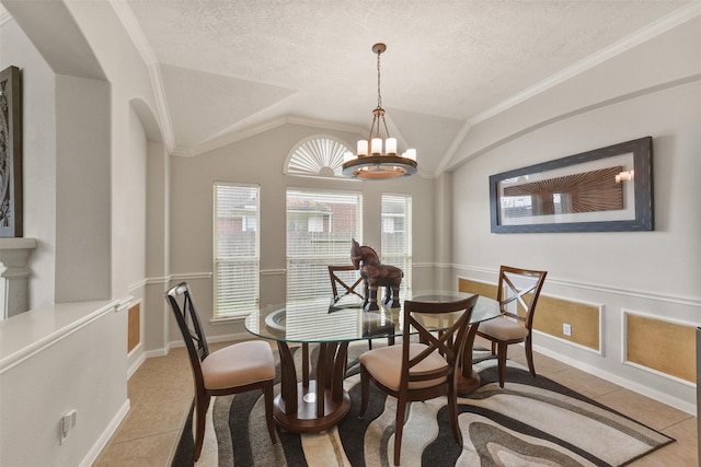 dining area with a notable chandelier, vaulted ceiling, a textured ceiling, and light tile patterned floors