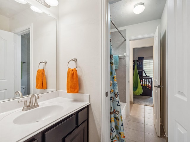 full bathroom featuring tile patterned flooring, shower / tub combo with curtain, and vanity