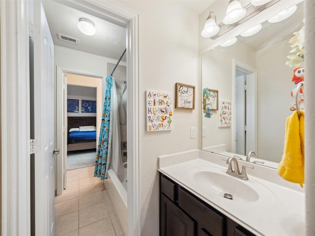 full bathroom with shower / tub combo, vanity, visible vents, and tile patterned floors