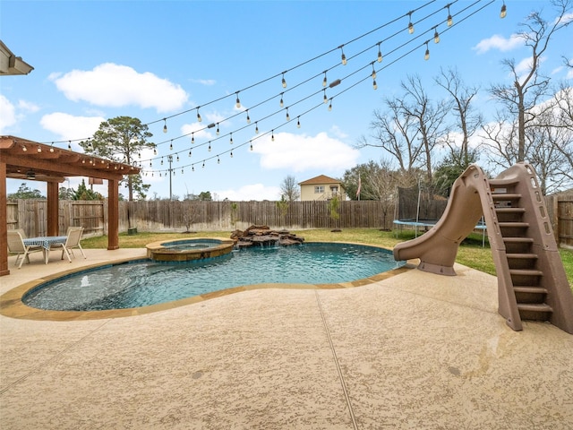 view of pool featuring a water slide, a fenced backyard, a pool with connected hot tub, a trampoline, and a patio area