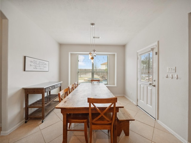 dining area featuring light tile patterned floors, plenty of natural light, visible vents, and baseboards