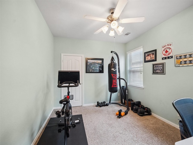 exercise room with carpet floors, baseboards, and a ceiling fan