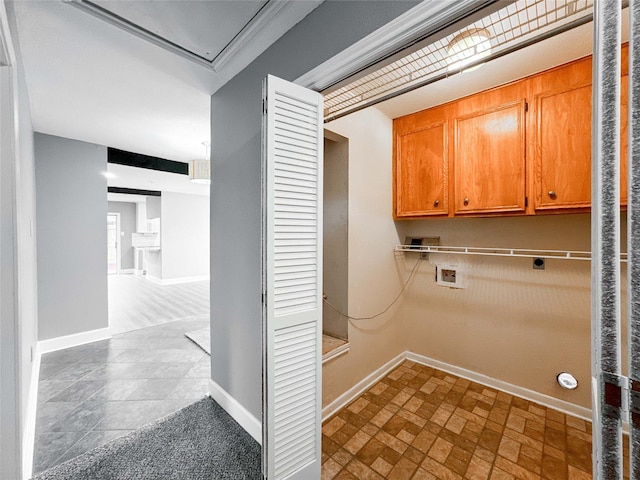 clothes washing area featuring baseboards, washer hookup, cabinet space, and electric dryer hookup