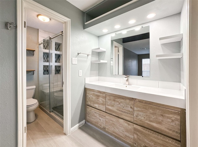 full bath with baseboards, a shower stall, toilet, and vanity