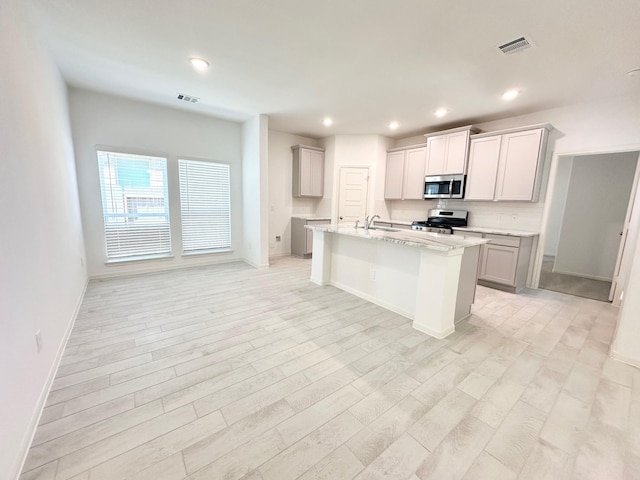 kitchen featuring appliances with stainless steel finishes, recessed lighting, visible vents, and a sink