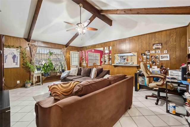 living room with wood walls, light tile patterned floors, a ceiling fan, and beamed ceiling