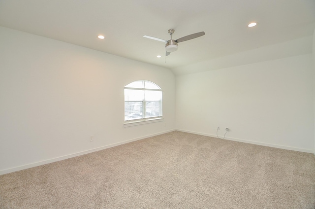 carpeted empty room with lofted ceiling, recessed lighting, and baseboards