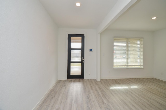 foyer with light wood finished floors, recessed lighting, and baseboards