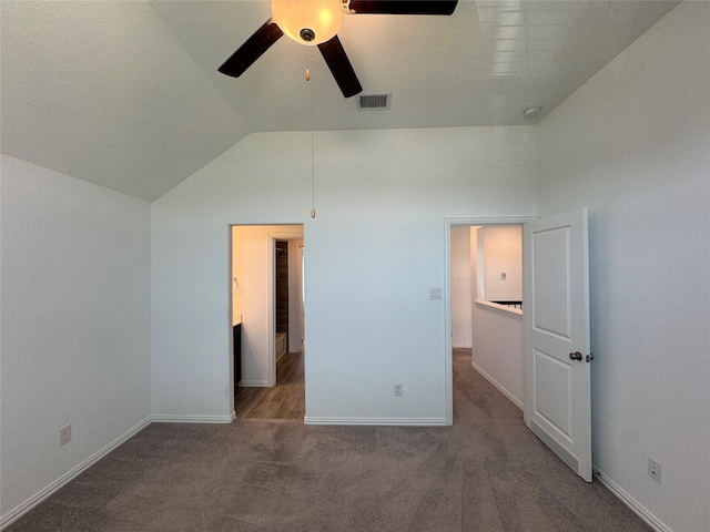 unfurnished bedroom with baseboards, visible vents, ceiling fan, vaulted ceiling, and carpet floors