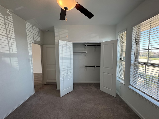 unfurnished bedroom with a ceiling fan, carpet, a closet, and baseboards