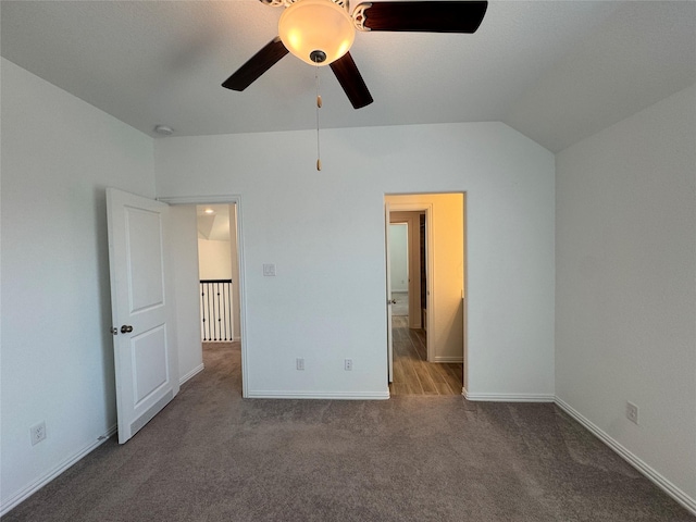 unfurnished bedroom with lofted ceiling, carpet, a ceiling fan, and baseboards