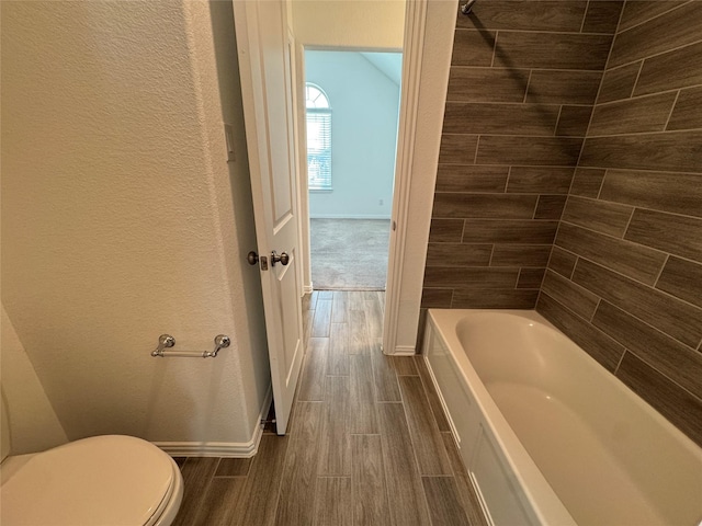 full bath with toilet, baseboards, and wood finish floors