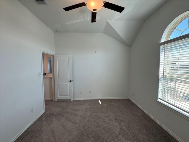 interior space featuring lofted ceiling, carpet floors, a ceiling fan, visible vents, and baseboards