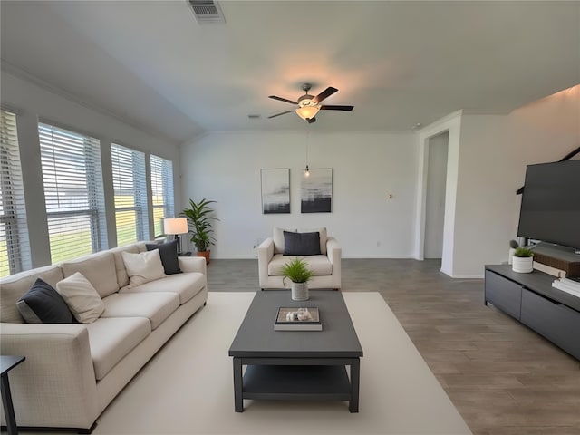 living room with lofted ceiling, visible vents, ceiling fan, and wood finished floors