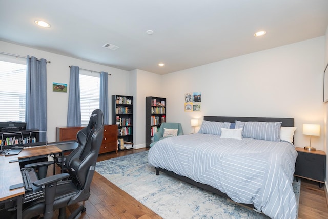 bedroom featuring dark wood-style flooring, visible vents, and recessed lighting