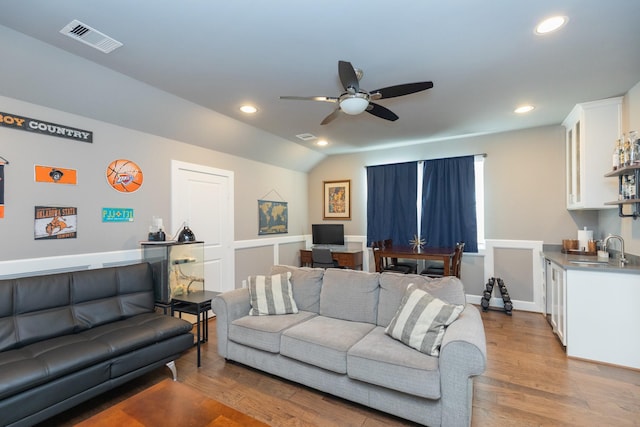 living room featuring a ceiling fan, wood finished floors, visible vents, and recessed lighting