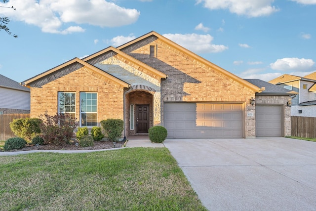 view of front of property featuring brick siding, concrete driveway, a front yard, fence, and a garage