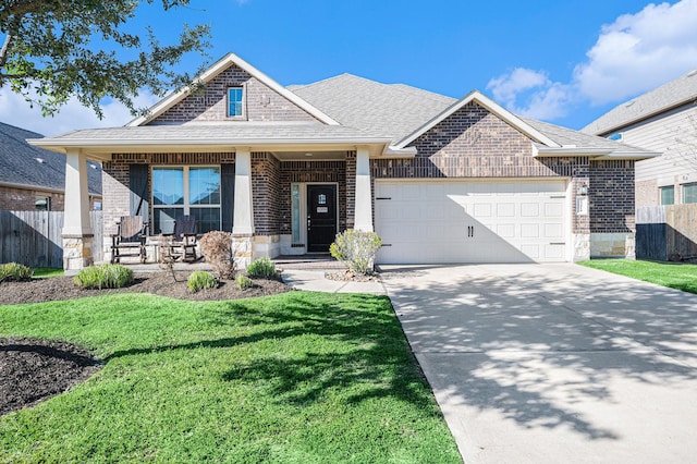 view of front of home featuring driveway, an attached garage, covered porch, fence, and brick siding