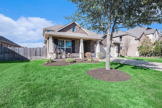 view of front of house with driveway, covered porch, fence, and a front yard