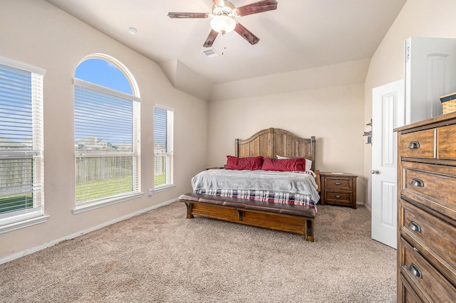 bedroom with baseboards, visible vents, light colored carpet, lofted ceiling, and ceiling fan