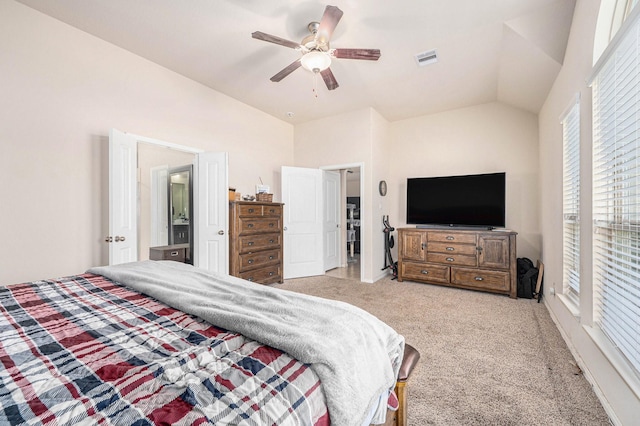 bedroom with lofted ceiling, visible vents, a ceiling fan, and light colored carpet