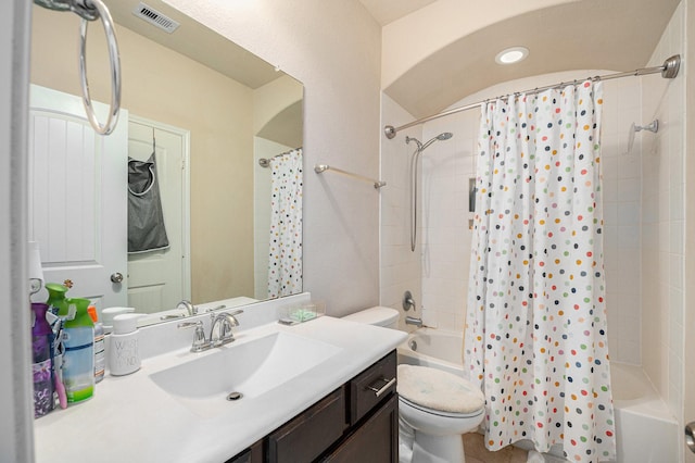 full bathroom featuring toilet, shower / tub combo, visible vents, and vanity