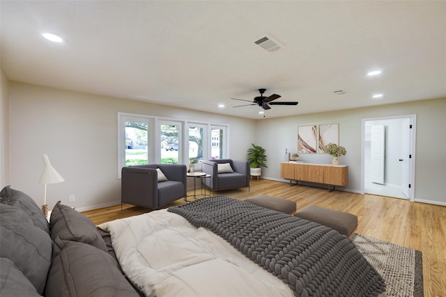 bedroom with baseboards, light wood-style floors, visible vents, and recessed lighting