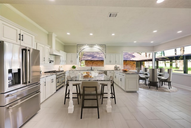 kitchen featuring stainless steel appliances, custom exhaust hood, visible vents, and decorative backsplash