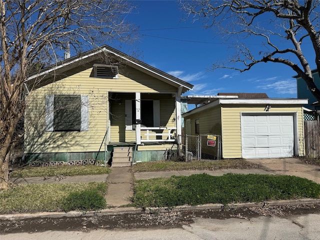 view of front facade with a garage, covered porch, and concrete driveway