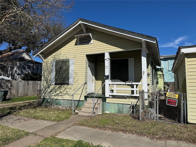 view of front facade with a porch and fence