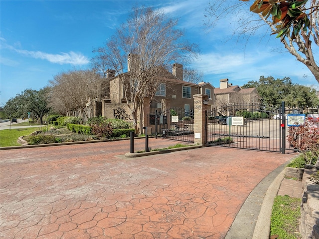 view of home's community with a residential view, a gate, and fence