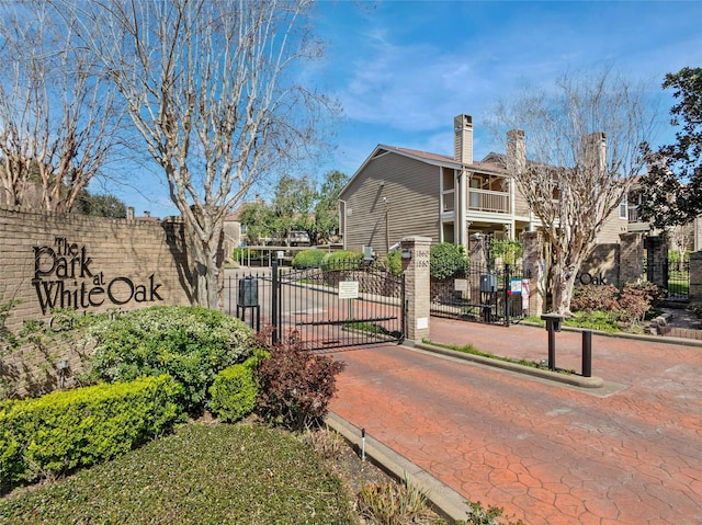 view of home's community with fence and a gate