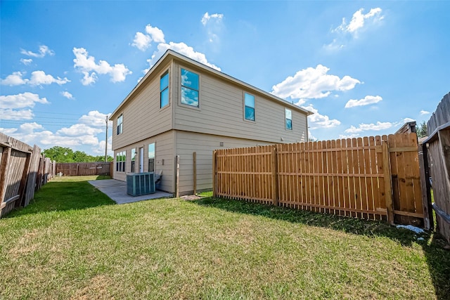 back of property with a patio, central AC unit, a lawn, and a fenced backyard