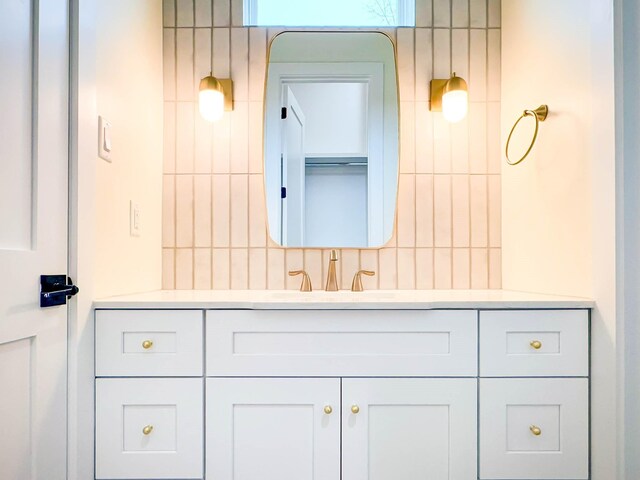 bathroom featuring vanity and decorative backsplash