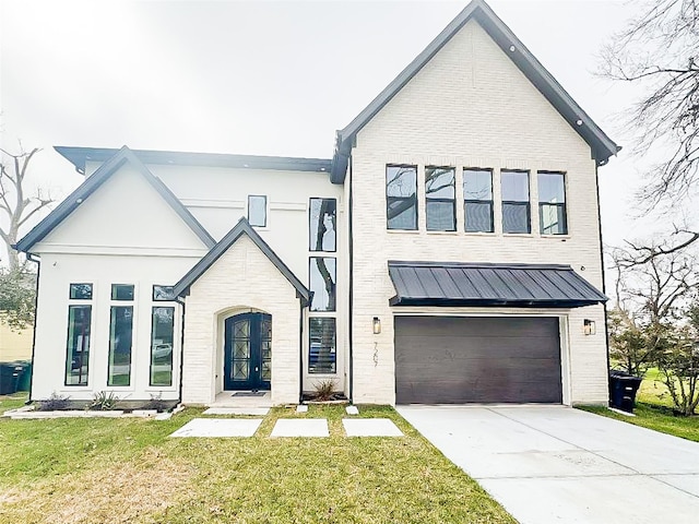 modern inspired farmhouse with an attached garage, brick siding, driveway, a standing seam roof, and a front yard