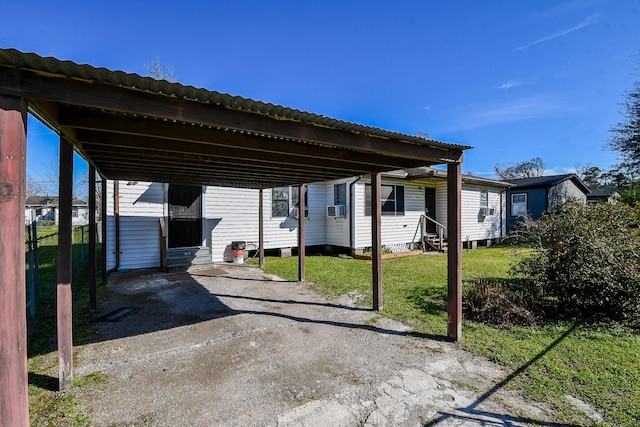 view of parking / parking lot featuring entry steps, driveway, and a detached carport