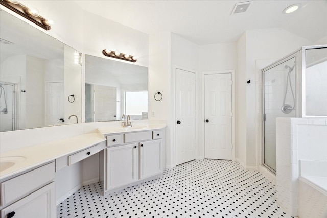 bathroom with a stall shower, visible vents, a closet, and vanity