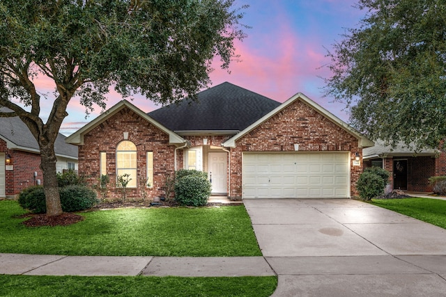 ranch-style home featuring brick siding, a yard, roof with shingles, a garage, and driveway