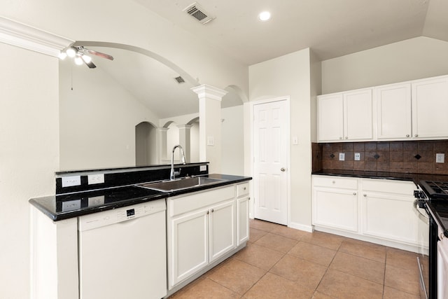 kitchen with a sink, white cabinetry, dishwasher, dark countertops, and decorative columns