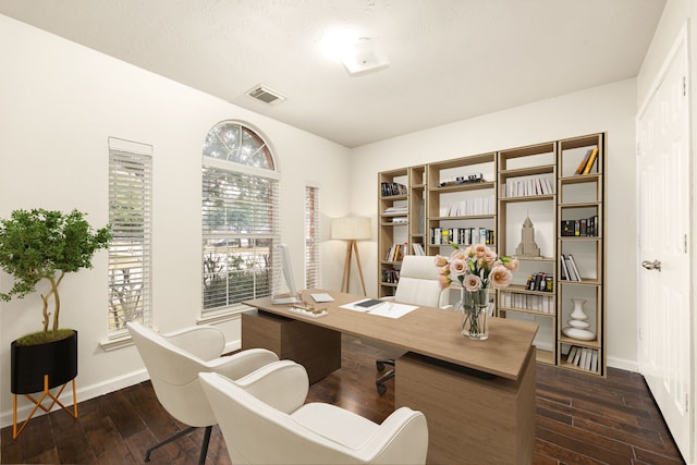 office area featuring dark wood-style floors, visible vents, and baseboards